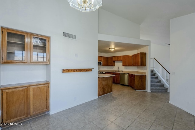 kitchen with an inviting chandelier, stainless steel dishwasher, and sink