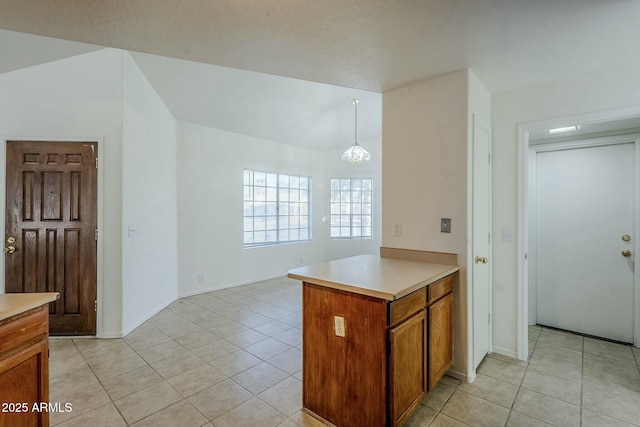 kitchen with kitchen peninsula, light tile patterned floors, a chandelier, and decorative light fixtures