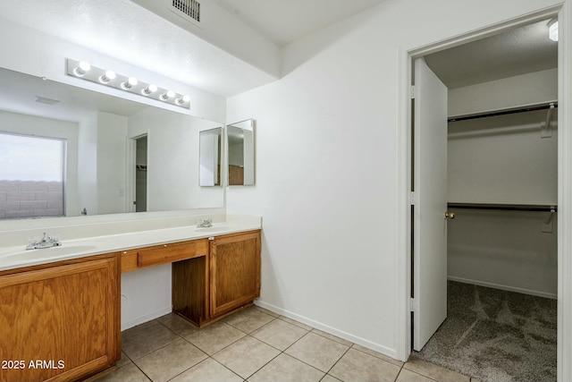 bathroom with tile patterned floors and vanity