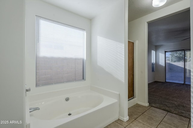 bathroom with tile patterned floors and shower with separate bathtub