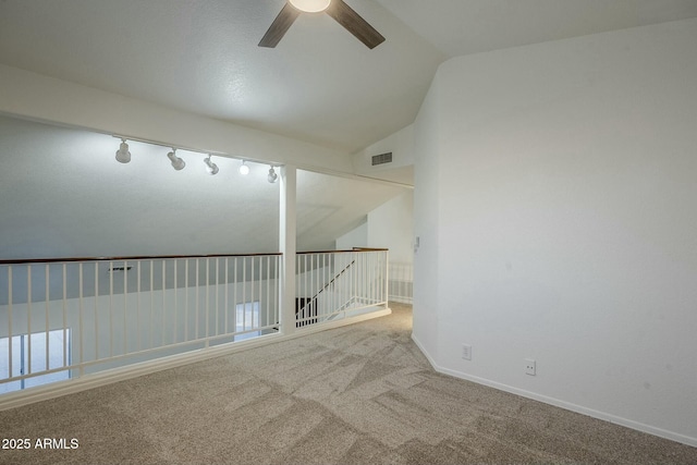 carpeted spare room with ceiling fan and lofted ceiling