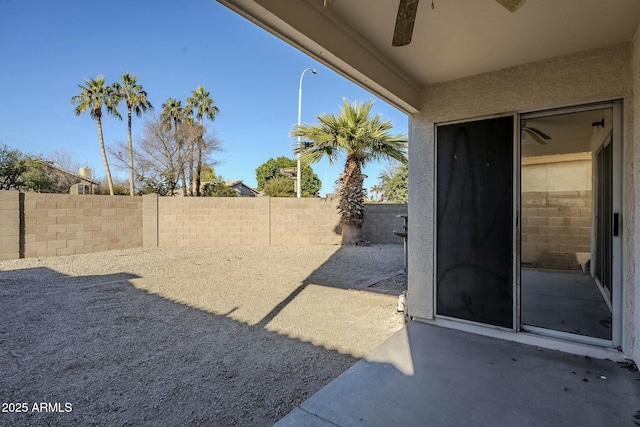 view of yard with a patio and ceiling fan