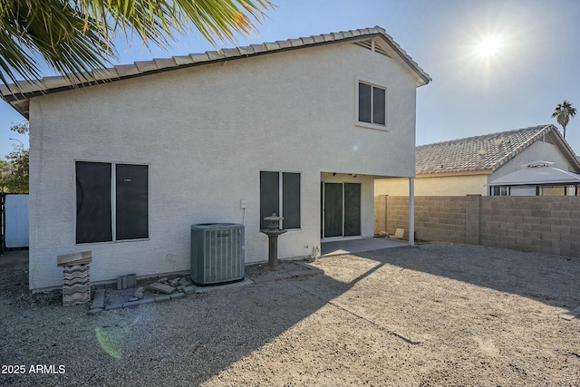 back of house with a patio and central air condition unit