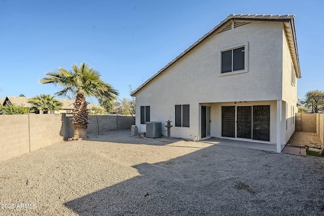 rear view of house featuring cooling unit and a patio