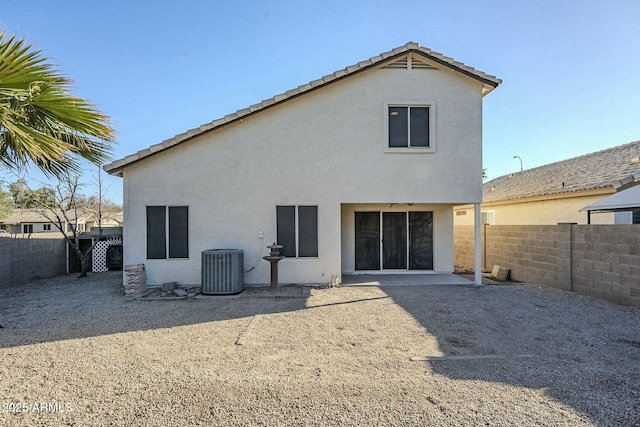 rear view of house with a patio area and central air condition unit