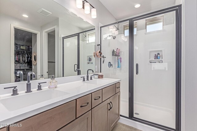 2499 S Entwistle St, Gilbert, AZ 85295 - full bathroom featuring a stall shower, double vanity, and a walk in closet