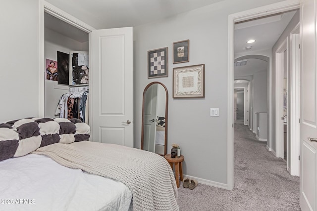 2499 S Entwistle St, Gilbert, AZ 85295 - bedroom with light carpet, arched walkways, baseboards, and recessed lighting