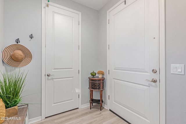 2499 S Entwistle St, Gilbert, AZ 85295 - doorway with light wood finished floors and baseboards