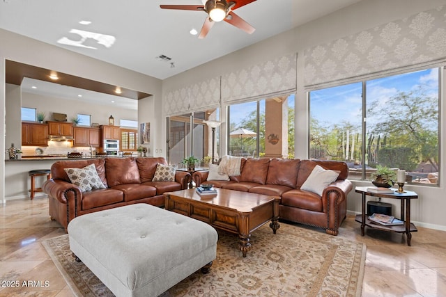 living room with a wealth of natural light and ceiling fan