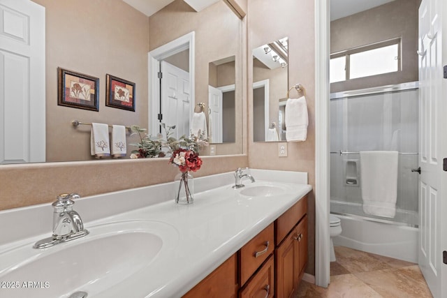 full bathroom with tile patterned flooring, vanity, toilet, and shower / bath combination with glass door