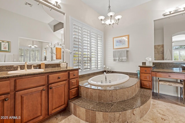 bathroom with tiled bath, vanity, vaulted ceiling, and a notable chandelier