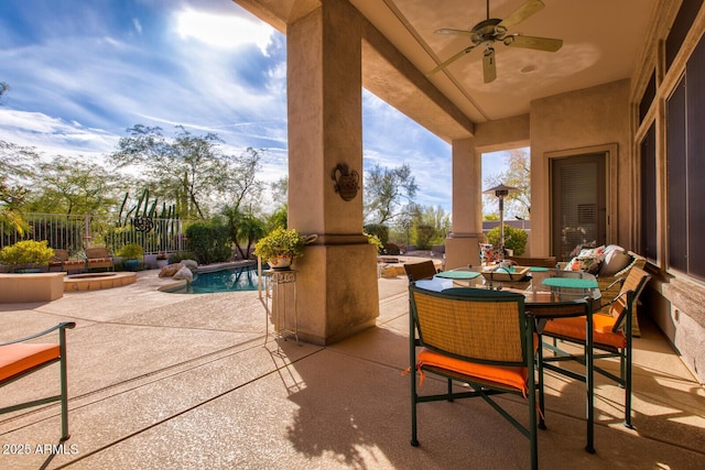 view of patio featuring a fenced in pool and ceiling fan