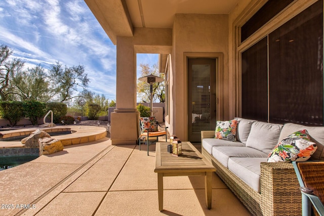 view of patio with an in ground hot tub