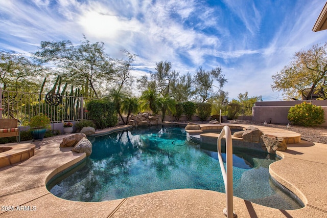 view of swimming pool featuring an in ground hot tub