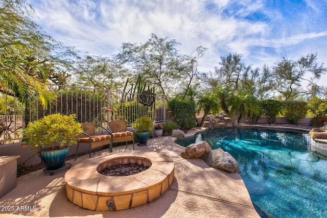 view of pool with a fire pit and a patio area