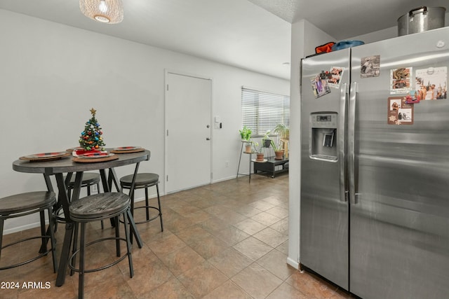 kitchen featuring stainless steel fridge with ice dispenser