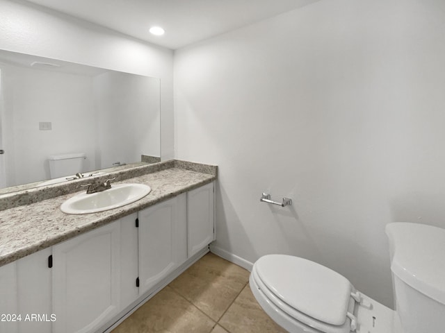 bathroom with tile patterned floors, vanity, and toilet