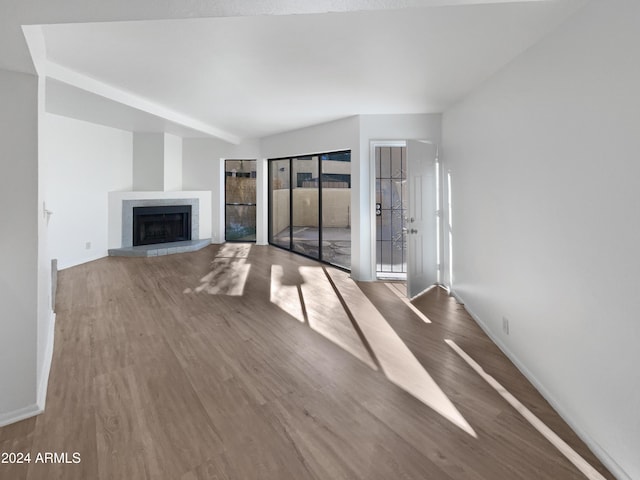 unfurnished living room featuring a fireplace and hardwood / wood-style floors