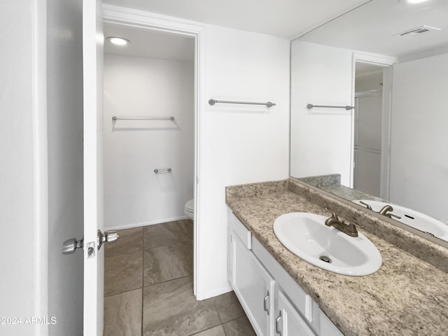 bathroom with tile patterned floors, vanity, and toilet