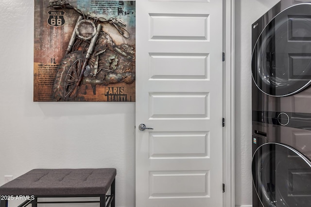 washroom featuring stacked washer and clothes dryer