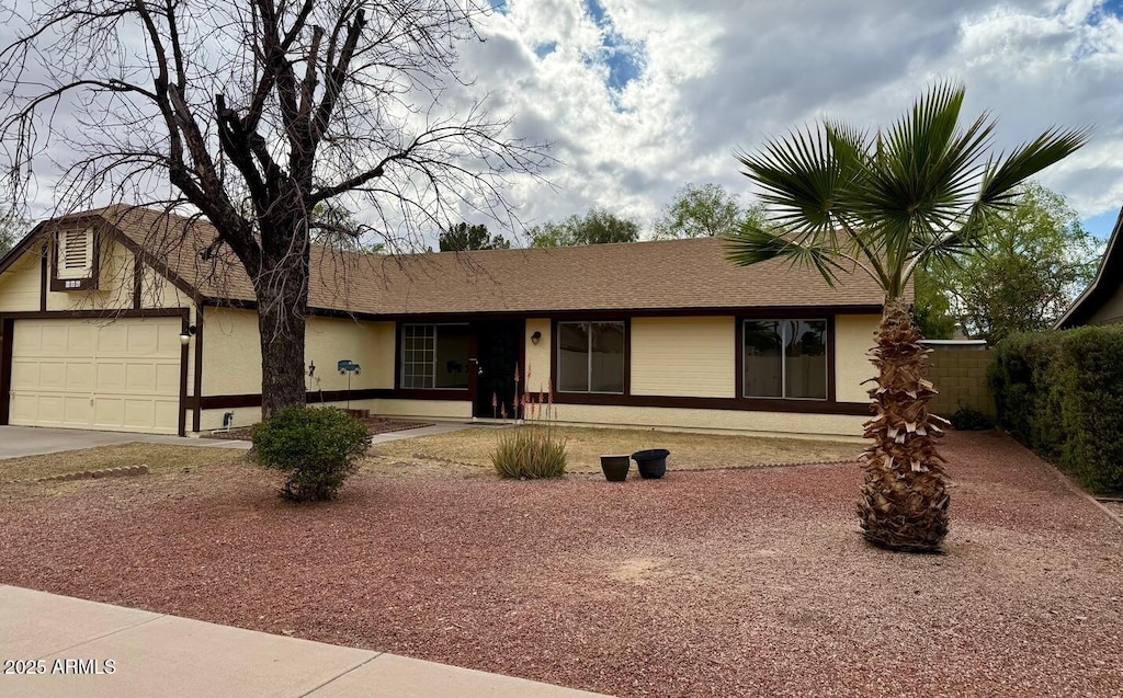 single story home with stucco siding, concrete driveway, and an attached garage