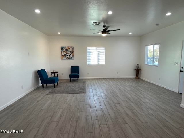 unfurnished room with ceiling fan, a healthy amount of sunlight, and light hardwood / wood-style floors