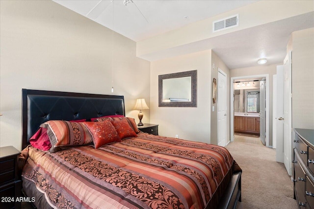 carpeted bedroom featuring connected bathroom