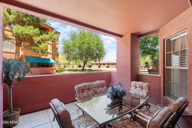 view of patio featuring a balcony