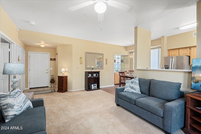 living room featuring light colored carpet and ceiling fan