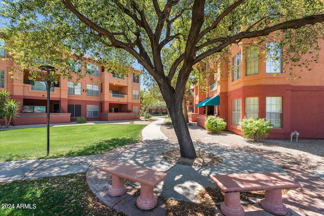 view of home's community with a yard