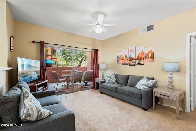 living room featuring ceiling fan and light colored carpet