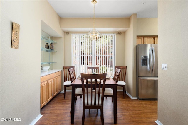 dining room featuring dark hardwood / wood-style flooring and an inviting chandelier