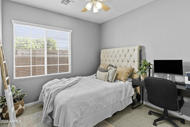 bedroom with light carpet and ceiling fan