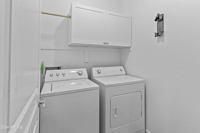 laundry area with cabinets and independent washer and dryer