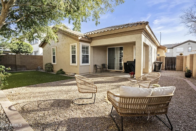 back of property featuring a patio area and a yard