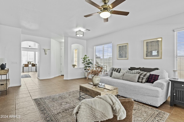 tiled living room with ceiling fan