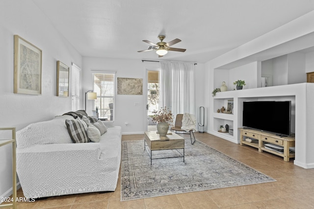 tiled living room with built in shelves and ceiling fan