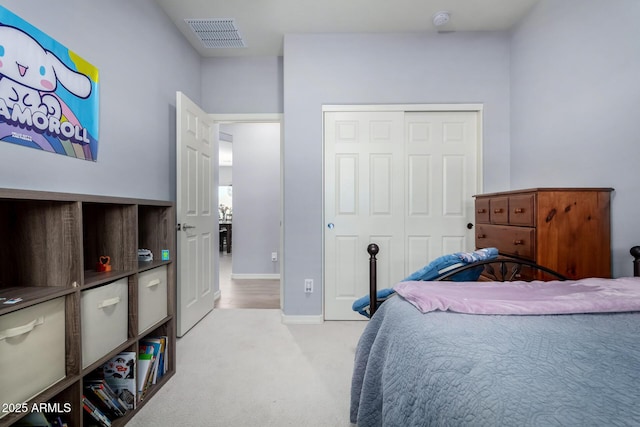 bedroom featuring light colored carpet and a closet