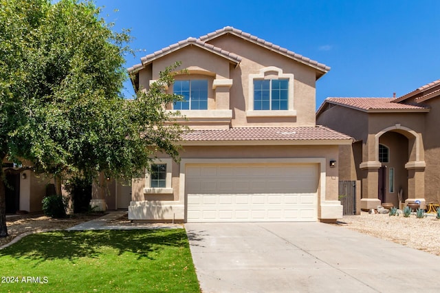 mediterranean / spanish-style home with a garage