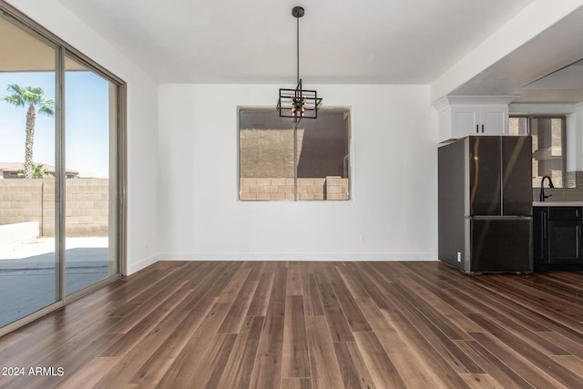 interior space featuring hardwood / wood-style flooring and a chandelier