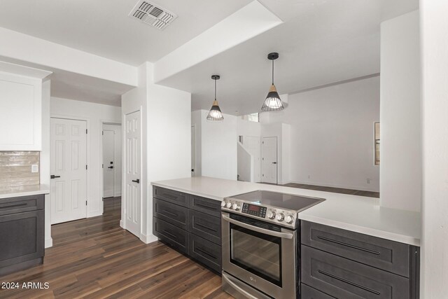 kitchen with dark wood-type flooring, stainless steel appliances, pendant lighting, white cabinets, and sink