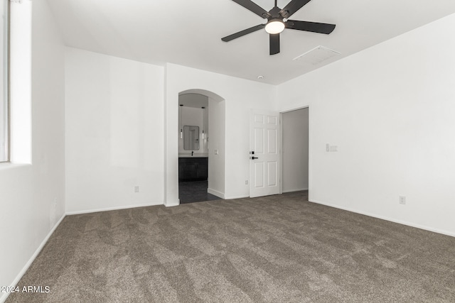 unfurnished bedroom with ceiling fan, carpet flooring, and ensuite bathroom