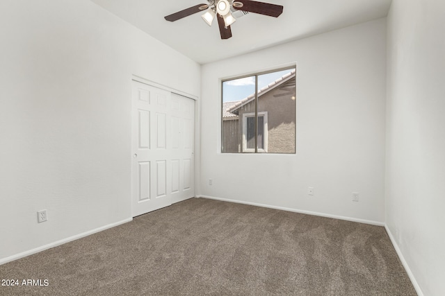 unfurnished room with ceiling fan and carpet flooring