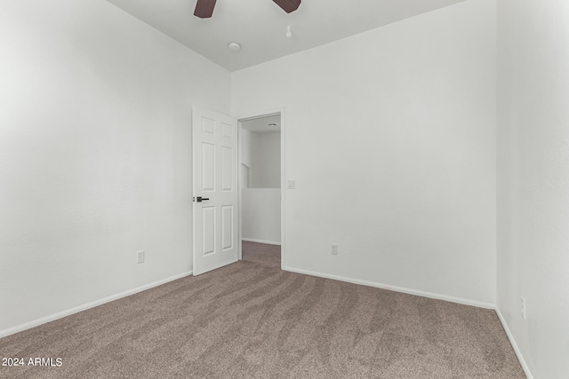 spare room featuring ceiling fan and carpet floors