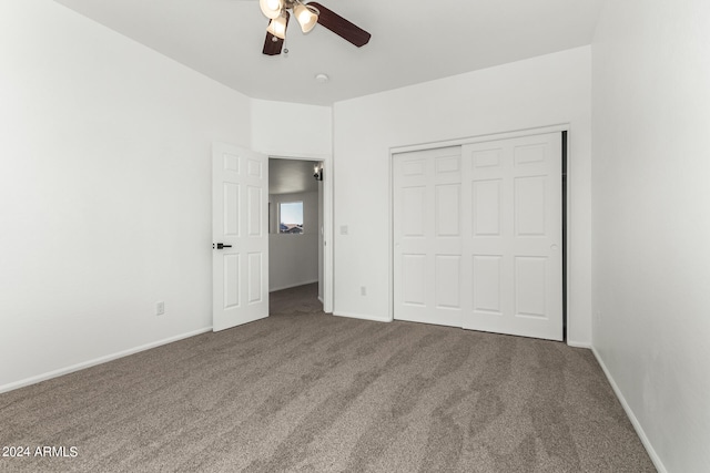 unfurnished bedroom with ceiling fan, a closet, and carpet