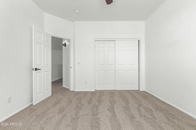 unfurnished bedroom featuring a closet, ceiling fan, and carpet floors