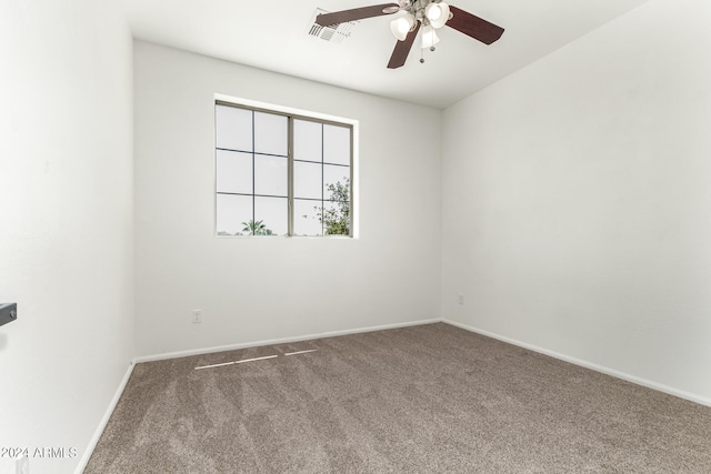 unfurnished room featuring ceiling fan and carpet