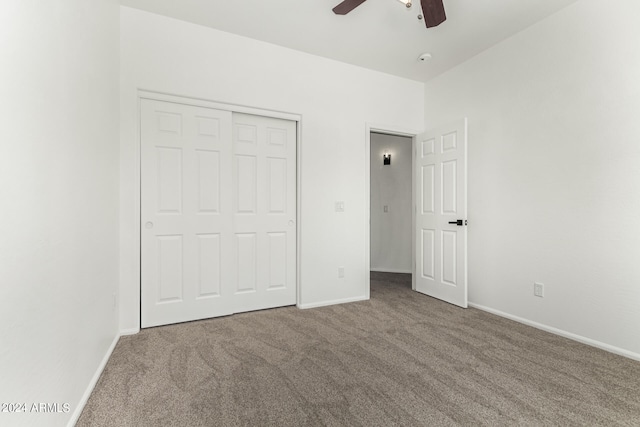 unfurnished bedroom with ceiling fan, carpet flooring, and a closet