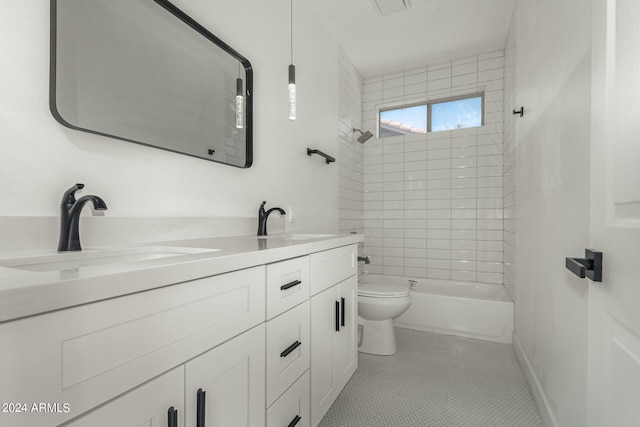 full bathroom with tile patterned floors, tiled shower / bath combo, vanity, and toilet