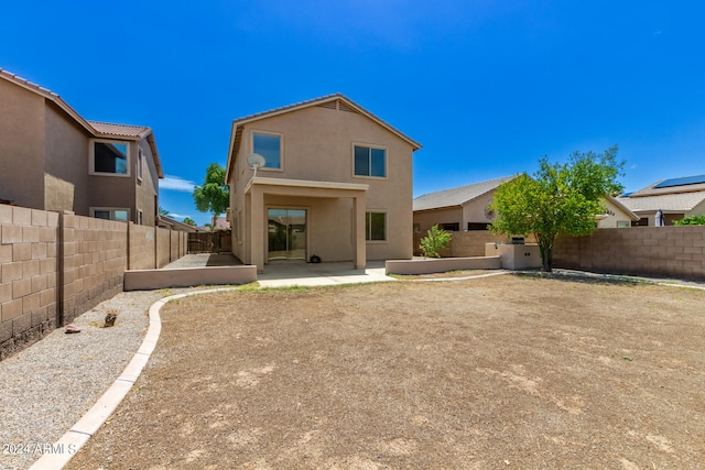 rear view of house featuring a patio